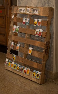 a wooden pallet with pictures hanging on it