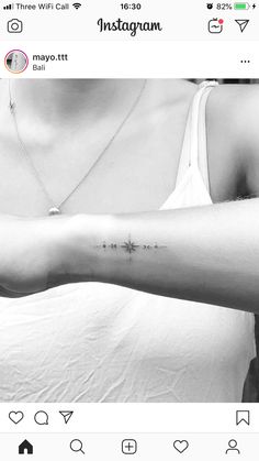 a woman's arm with a small star tattoo on the left side of her arm