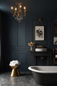 a bathroom with black walls, gold fixtures and a white bathtub in the middle