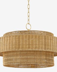 a large chandelier made out of wicker and gold chain hanging from the ceiling