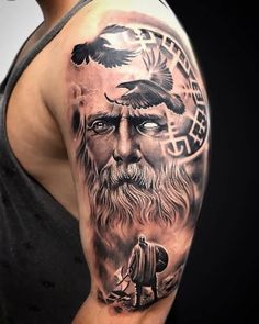 a man's arm with an image of a bearded man and two birds on it