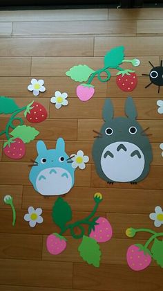 the floor is covered with paper cut outs and strawberries, strawberrys, and totoro