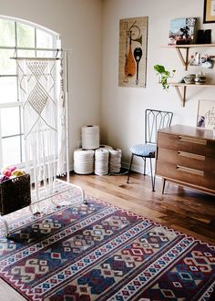 a living room with a rug, table and chairs