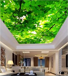 a living room filled with furniture and a ceiling covered in green leafy leaves on the ceiling