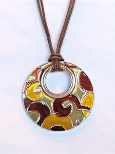 Lia Sophia "AMBER WAVES" Pendant Necklace  Up for auction is this Brand New, Beautiful Lia Sophia Pendant Necklace  This Pendant Necklace is Silver Toned with Beautiful wavy colors of Browns & Amber.  The Reverible side is all Silver Toned with a Textured Line design.  Sorry I didn't have a photo of the reverible side. The pendant has a leather chord style necklace.   Very Unique & Beautiful!!          The Necklace has an adjustable length of 16-19" Long.      This necklace is super fun and can be worn casual, or for dress-up!              Great for FALL!! Retail Value:  $34.00  So you know you will get a Great Deal!! (Can be viewed in the Spring/Summer 2010 and many other Lia Sophia Catalogs!!) Perfect gift for that special someone or for yourself!! Great Low Price!  Fast Shipping!  No Ha Funky Jewelry Necklaces, Culture Jewelry, 70s Jewelry, Dope Jewelry Accessories, Accessory Inspo, Eco Jewelry, Quirky Jewelry, Talisman Jewelry, Earthy Jewelry