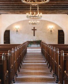 an empty church with pews and chandelier