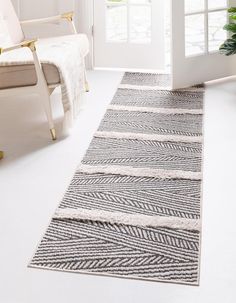 a white and black area rug in front of a door