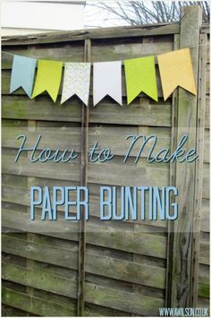 a sign that says how to make paper bunting on the side of a wooden fence