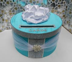 a blue hat box with a white bow on top and the name candis written on it