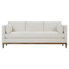 a white couch sitting on top of a wooden frame