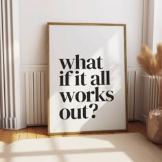 a white framed poster with the words what if it all works out? next to a plant