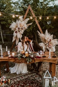 an instagram page with two people sitting at a table surrounded by flowers and candles