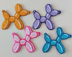 four different colored bows on a white surface