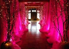 the hallway is decorated with pink lights and trees