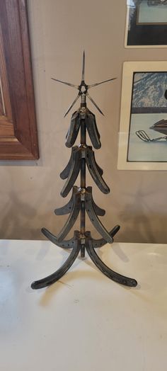 a small wooden christmas tree sitting on top of a table