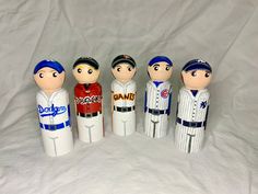 a group of baseball figurines sitting on top of a white sheet