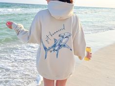 Dive into style with our "Get Hammered" hoodie, featuring a watercolor hammerhead shark design on the back. Perfect for those who love a good pun and a splash of oceanic flair, this hoodie is your go-to for cozy comfort and making a statement. Whether you're hitting the beach or just chilling with friends, let everyone know you're ready to "get hammered" in the most stylish way possible! PRODUCT FEATURES ⭐Medium-heavy fabric, spacious kangaroo pouch pocket, color-matched drawcord ⭐50% US cotton, Ocean Inspired Clothes, Ocean Aesthetic Clothes, Beachy Hoodies, Beachy Winter Outfits, Beachy Sweatshirt, Ocean Sweatshirt, Summer Hoodies, Ocean Outfits, Respect The Locals