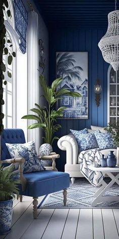 a blue and white living room with two couches, a coffee table and potted plants