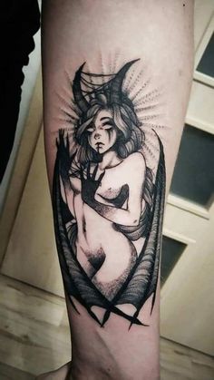 a black and white tattoo on the leg of a woman with an arrow in her hand