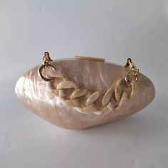 Elegant, Unique, Coastal Charm – Unveil the beauty of coastal elegance with the Island Boho Pearl Shell Clutch Bag. Designed to captivate with its realistic seashell shape and iridescent pearly shine, this acrylic clutch bag is perfect for beach lovers and free-spirited souls who embrace the whispers of the ocean. Why We Love It... The Island Boho Pearl Shell Clutch Bag offers a harmonious blend of bohemian allure and beachside sophistication. The realistic seashell shape evokes the serene beaut Boho Clutch Bag, Shell Clutch, Purse Wedding, Bridal Clutch Bag, Boho Clutch, Acrylic Bag, Acrylic Clutch, Clutch Bag Wedding, Bridal Elegance