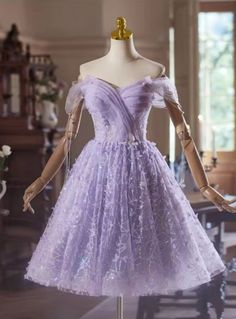 Completely mesmerizing! Elevate your homecoming look with this magical lavender dress, designed to make you shine. The stunning off-shoulder neckline draws attention to your collarbones, while the structured bodice provides support and a flattering fit. The delicate sparkle sprinkled throughout the flowing tulle fabric creates a fairytale-like effect as you move, ensuring all eyes are on you. With a knee-length A-line silhouette, itthe perfect blend of elegance and playfulness, allowing you to enjoy the night in both style and comfort. The subtle detailing, like floral appliques, adds a layer of sophistication to this already enchanting dress. Make your homecoming night unforgettable with a dress thatas memorable as you are. Light Purple Quinceanera Dresses Damas, Light Purple Dama Dresses, Cute Purple Dresses Short, Homecoming Dresses Purple, Light Purple Quinceanera Dresses, Cute Dance Dresses, Quinceanera Dama Dresses, Purple Castle, Purple Dress Short