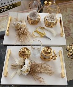 there are two trays that have gold and white decorations on them, one is empty