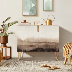 a living room with an abstract painting on the sideboard and plants in vases