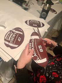 a woman is cutting up some stickers on a table