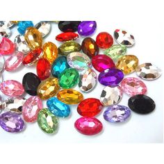 many different colored stones on a white surface