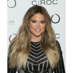 an image of a woman with long hair wearing black and silver dress on the red carpet