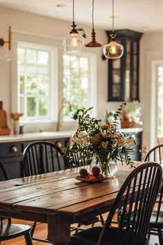 a wooden table with chairs around it in a kitchen