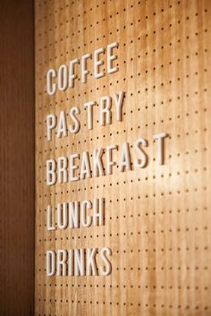 a wooden sign that says coffee pastry breakfast lunch drinks on the side of a wall