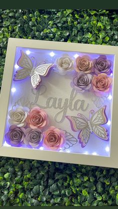 an illuminated frame with flowers and butterflies on it that says jayla in cursive writing