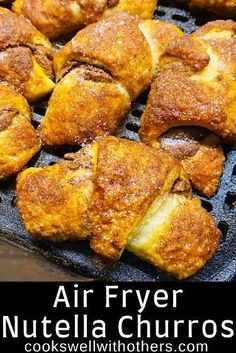 an air fryer filled with croissants and powdered sugar