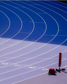 a man is running on a blue track