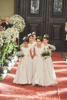 the flower girls are walking down the aisle