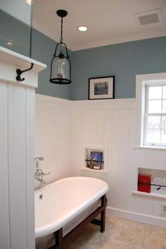 a white bath tub sitting next to a window