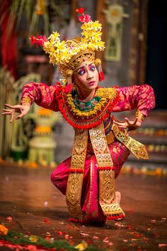 a woman in an elaborate costume is dancing