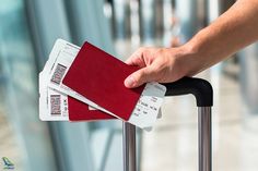 a person holding onto a red piece of luggage with some paper in it's hand