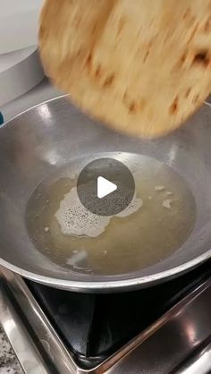 a frying pan on top of a stove with a wooden spatula in it