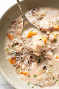 a white bowl filled with chicken and dumpling soup