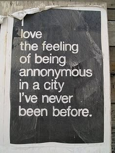 a sign that says love is the feeling of being anonymous in a city i've never been before