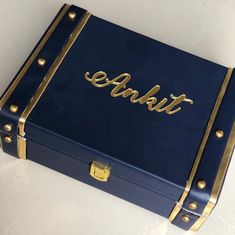 a blue suitcase with gold lettering on the lid and handles that says,'ablet '