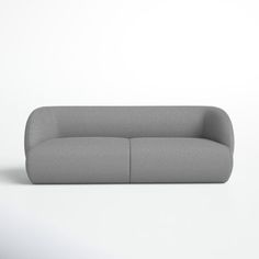 a gray couch sitting on top of a white floor