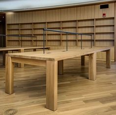 an empty library with benches and bookshelves