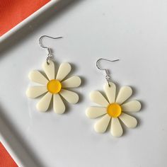 Flower power to the max! These fun, funky oversized flower earrings bring the perfect retro flair to any outfit.  These earrings measure approximately 2.4 inches in length. Each flower is about 1.6 inches in diameter. These earrings feature silver-plated ear wires, so they're great for sensitive ears. Sterling silver is also hypoallergenic and nickel-free.  As if that weren't enough, they're also ultra lightweight, weighing about 4 grams each. Vintage White Flower Drop Earrings, Retro White Flower Jewelry, Retro Flower-shaped Jewelry For Summer, Retro Flower-shaped Earrings For Gift, Retro Spring Flower Earrings Gift, White Daisy Flower Earrings For Spring, Trendy Flower Earrings, Trendy Flower Shaped Earrings, Vintage Flower Earrings For Summer