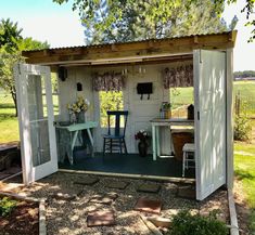 a small shed with two tables and chairs in it