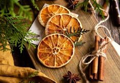 an orange cut in half sitting on top of a cutting board next to cinnamon sticks