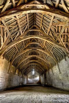 the inside of an old building with wooden beams and roof rafters on either side