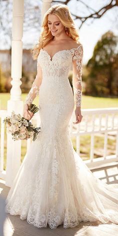 a woman in a wedding dress standing on a porch